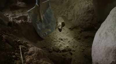 ‐ The team resumes digging
under the rock marked with an X, - Lost Gold of World War II