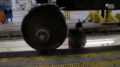 The three Italian engineers
are ready to bolt the new wheels - World's Busiest Train Stations