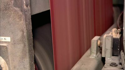 The tile surface gets a sanding. - How It's Made