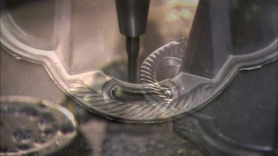 THEN IT REFINES THE HANDLE
SLOTS, FINALIZING THE SHAPE. - How It's Made