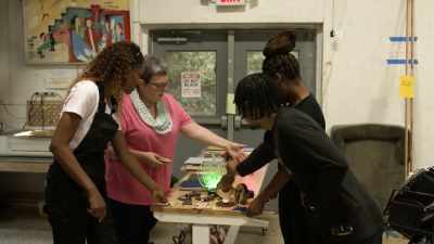THERE'S SOMEBODY MAKING ITEMS
FOR THEIR ONLINE STORE. - Harlem Globetrotters: Play It Forward