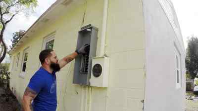 They install a new panel
and run fresh wires, - Zombie House Flipping