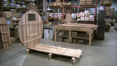 THEY MOUNT THE FRONT AND BACK
WALLS ONTO THE BOTTOM SECTION. - How It's Made