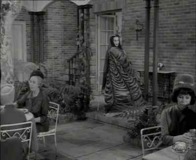 This ensemble has a cape
made of tufted coffin lining... - The Munsters