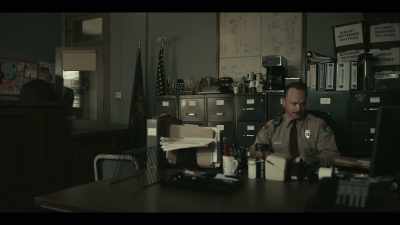 (TV playing indistinctly) - American Rust