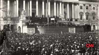 UNCHARACTERISTICALLY, HE IS
CARRYING A CANE, HIS TOP HAT AND - Lincoln: Divided We Stand