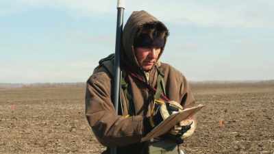 Walking back and forth
in a cornfield with a tool, - Beyond Oak Island