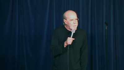 -"We interrupt this program."
-(AUDIENCE LAUGHING, CHEERING) - George Carlin's American Dream