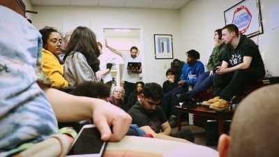 - We're here!
- Can I sit on the floor?
Is that okay? - The Unmaking of a College