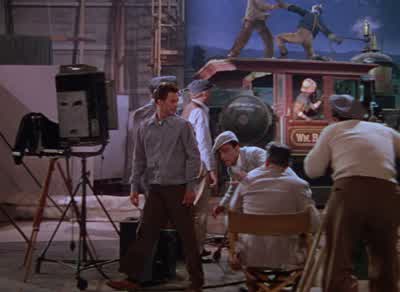 Why bother to shoot this Release the old one under a new titleYou've seen one you've seen them allWhy'd you say that What's the matterThat's what that Kathy selden said to me that nightThat's three weeks ago You still thinking about thatI can't get her - Singin' in the Rain