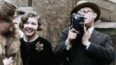 WHEN HE'S NOT FILMING NEWSREELS, - America in Color