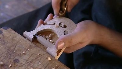 WITH A FILE, HE CUTS GROOVES
TO CRADLE THE STRINGS. - How It's Made