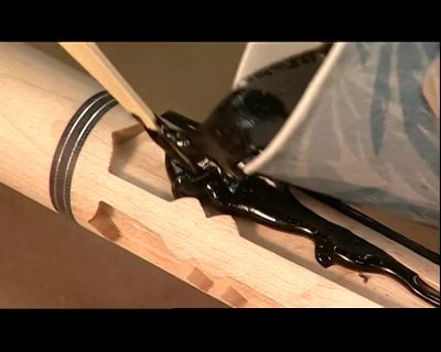 WITH A STICK, HE SLATHERS
A THICK EPOXY MIXTURE - How It's Made