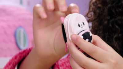 With the tiny little pink ears
and the straps. - Gabby's Dollhouse