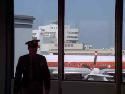 WOMAN ( over loudspeaker ):
Flight 4 for New York, now loading Gate 7. - The Streets of San Francisco