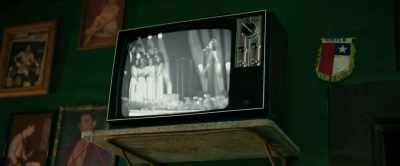 [woman singing on TV] - The Movie Teller