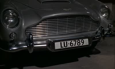 Here's a nice little transmitting device called a homerYou prime it by pressing that back like this You seeThe smaller model is now standard field issueto be fitted into the heel of your shoeIts larger brother is magneticRight To be concealed in the car - Goldfinger