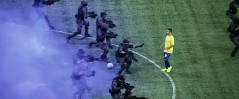 SPORTSCASTER: 50 to 60 armed men and women standing on the pitch