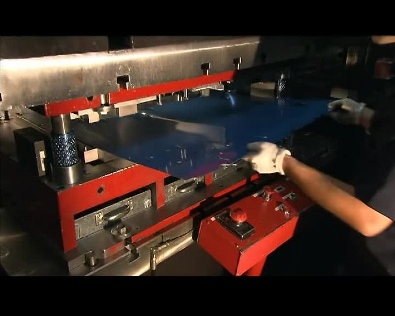 A 300-TON PRESS THEN PERFORATES THE SHEET