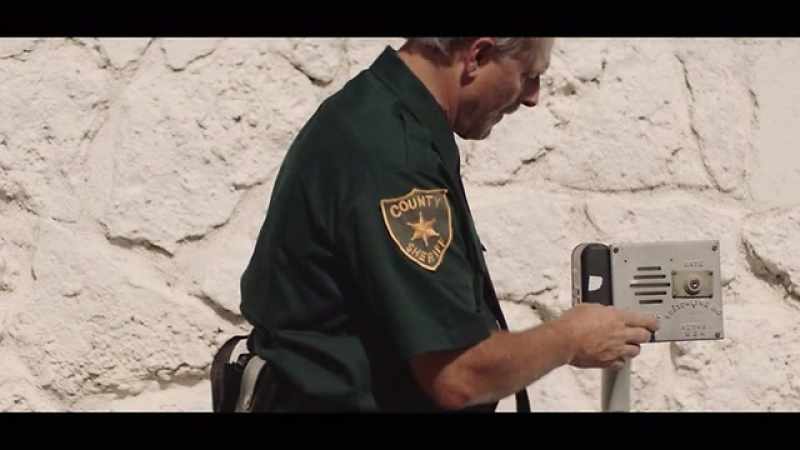 A Broward County sheriff comes to the gate and says