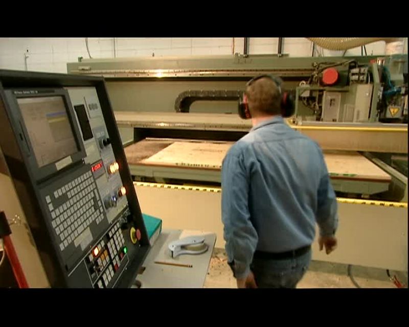A COMPUTERIZED SAW CUTS OUT THE WOOD PIECES