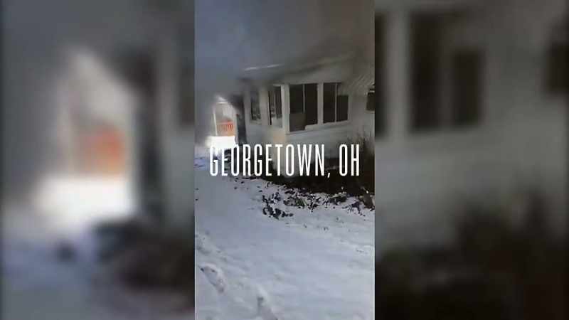 A man is relaxing on his couch when he hears a neighbor
