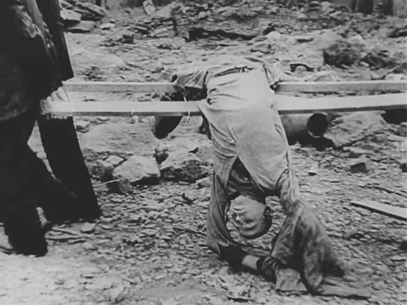 A priest administers last rites for the dead