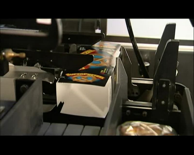 A ROBOT ARM THEN PLACES EACH BAG INTO A CARDBOARD BOX