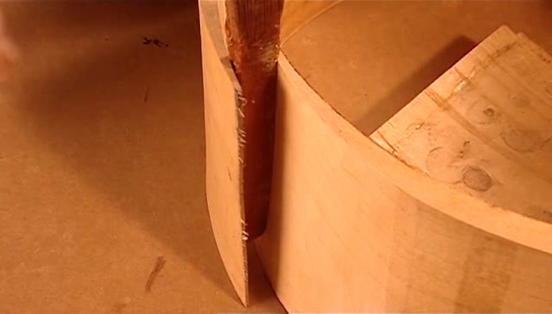 A WORKER PRIES APART THE ENDS