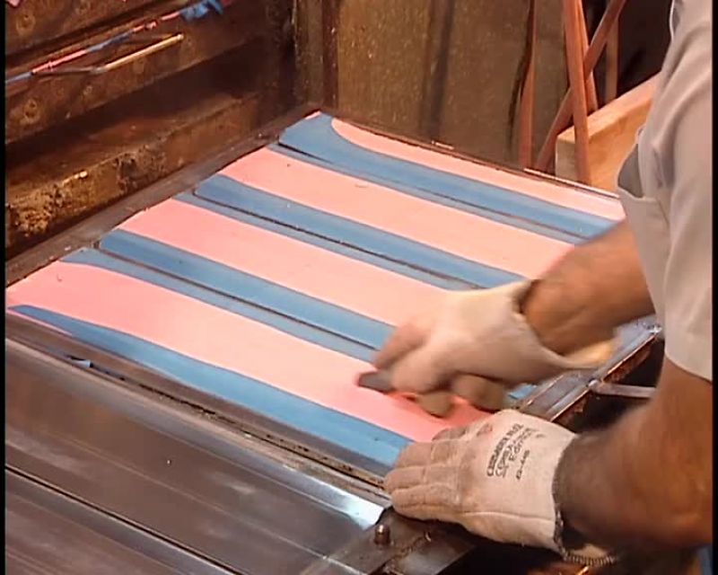 AFTER 12 MINUTES, WORKERS REMOVE THE TRAYS