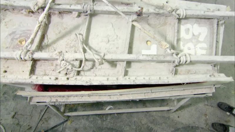 After closing the rudder mold, they insert a paper cone