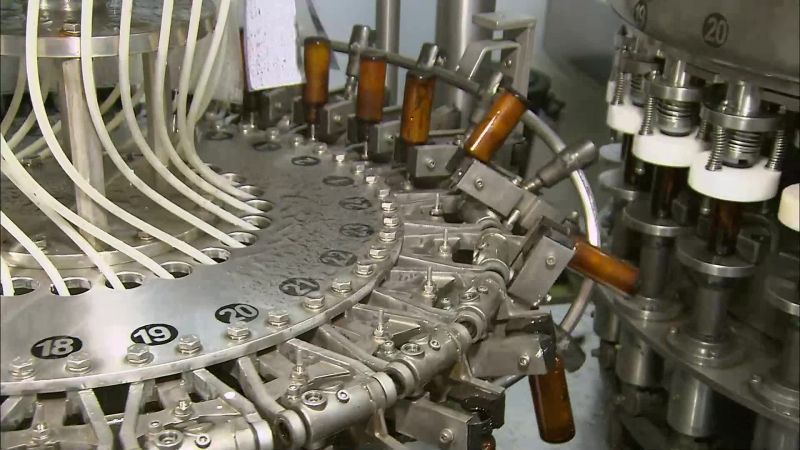 AFTER WASHING, THE BOTTLES MOVE TO THE NEXT MACHINE