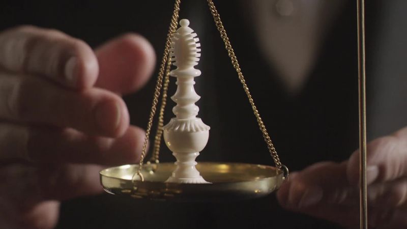 Ah. There is a rather thin metal which passes up through this chessman