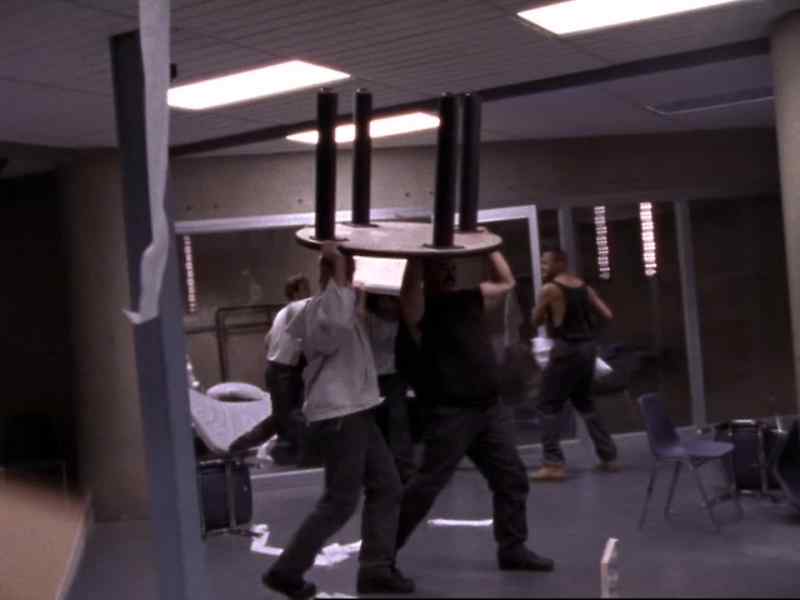 [alarm blaring] [inmates yelling]