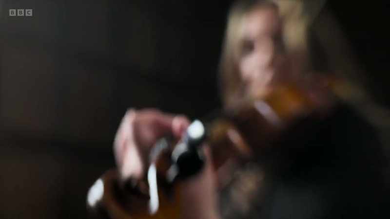 Alexia teaches violin to students
