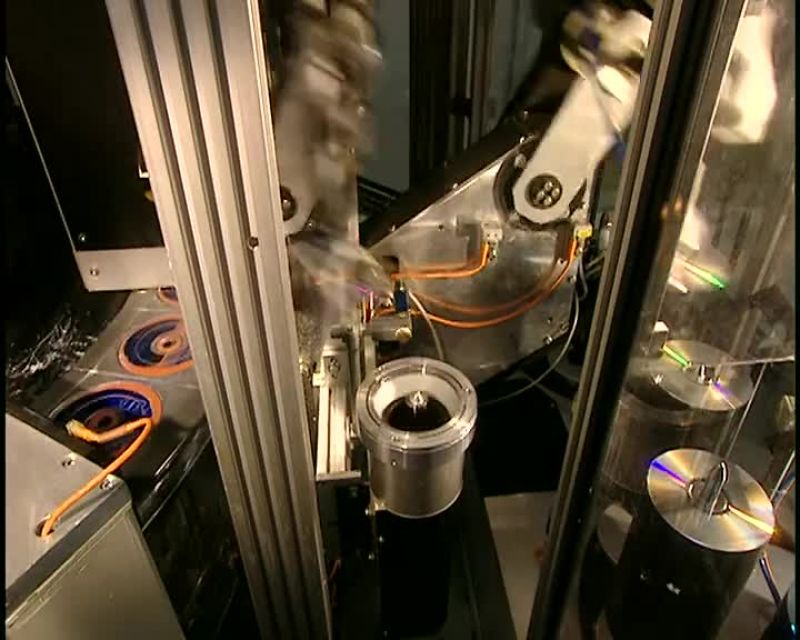 AND HERE IN THE PRESSING ROOM, THEY APPLY THE LABEL