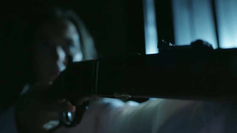 And she's armed with a rifle
