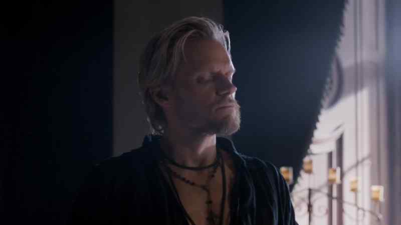 Aramis wears a jewelled crucifix