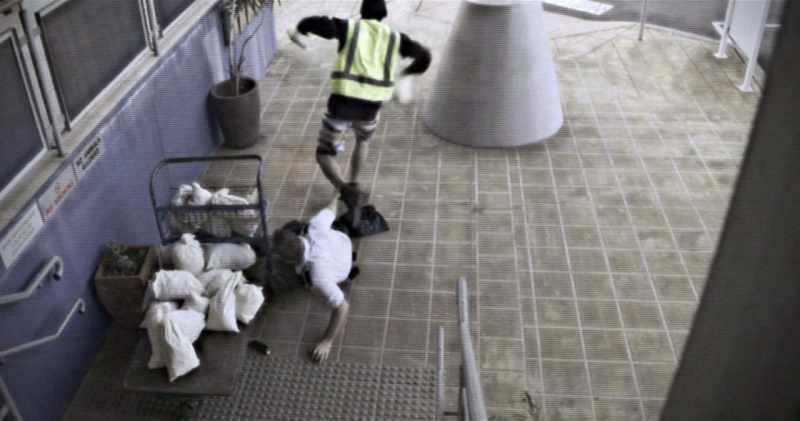 As he grabs the cash, the guard grabs his jeans