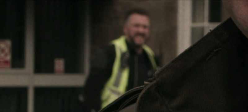 As he hurried past, he grinned at the camera