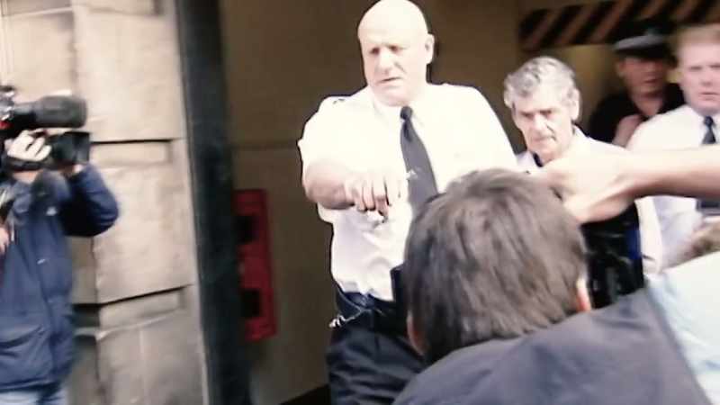 As he left court, he violently lashed out at photographers