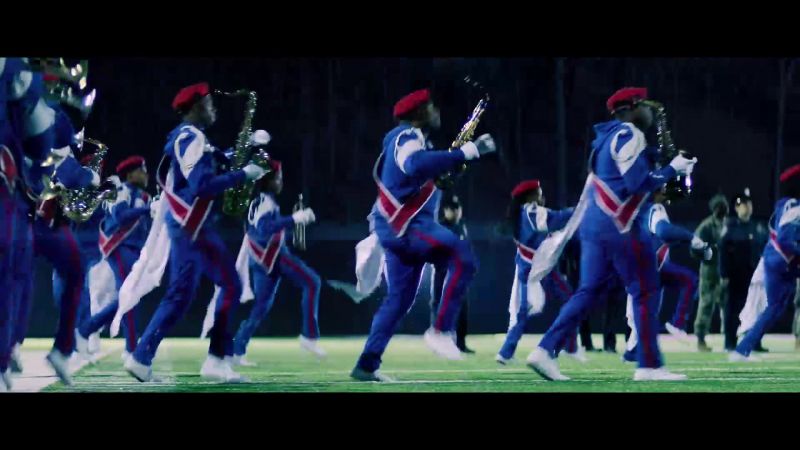 (BAND CONTINUES PLAYING UPBEAT MUSIC)