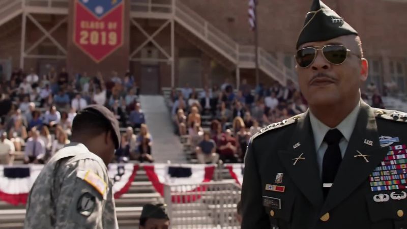 [band playing militaristic music]