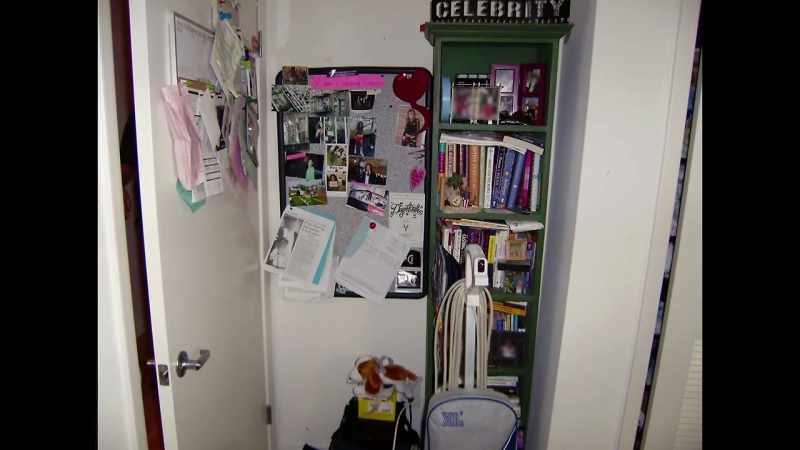 Behind one of the bookcases