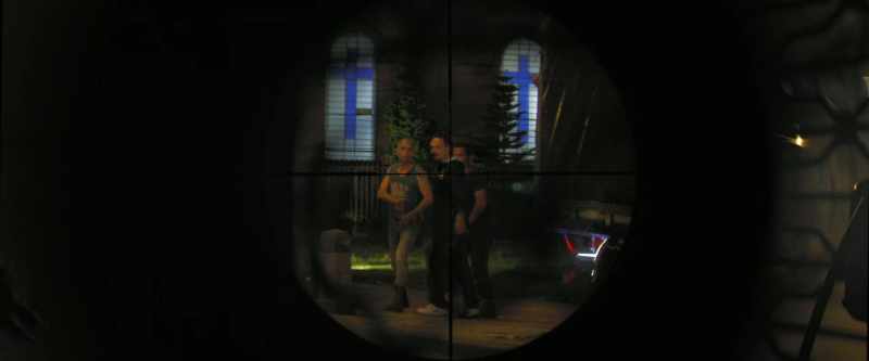 Behind the truck, what are they doing?