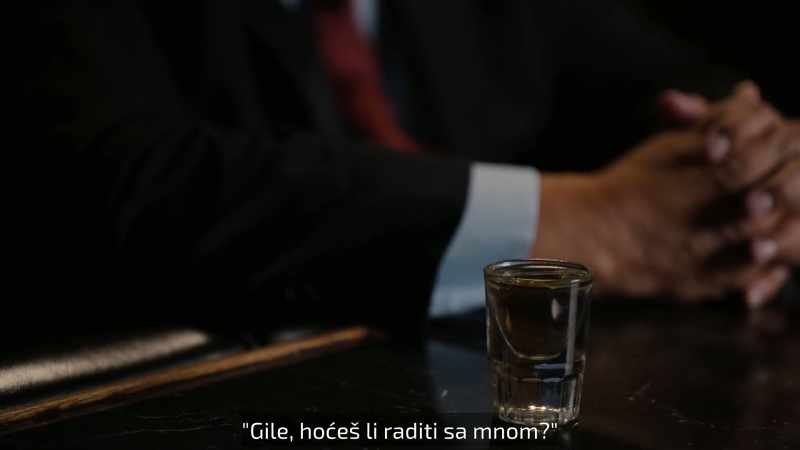 Both get a drink at the bar and he says