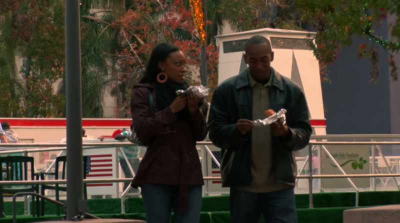 Buying hot dogs from a corner cart