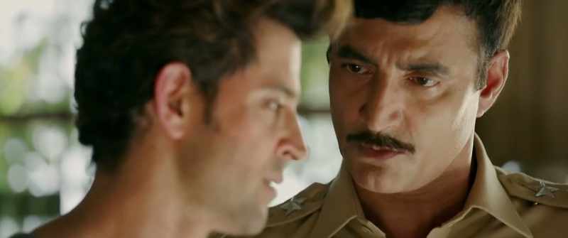 By placing Amit's handkerchief on Wasim's shoulder