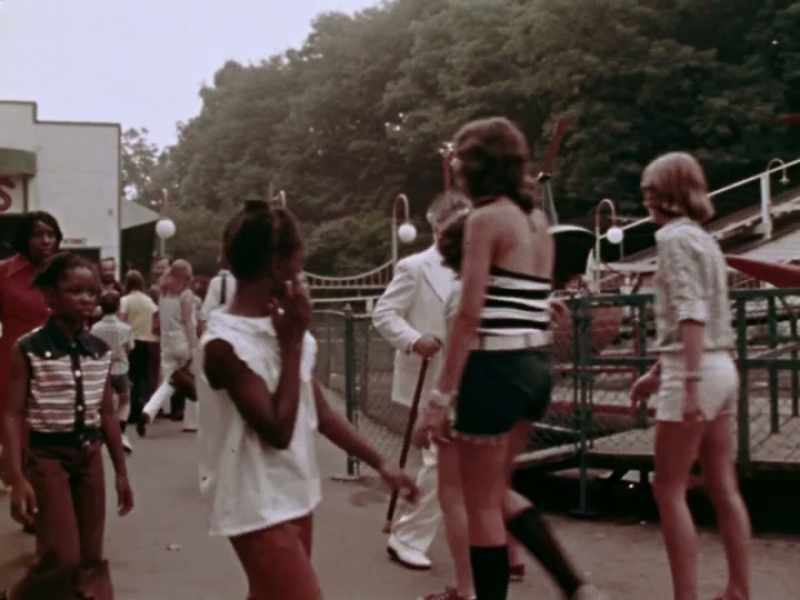 [ Carnival music playing, indistinct conversations ]