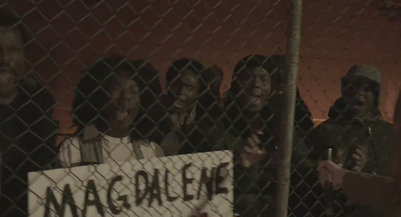 [chanting continues on TV] We are wide awake!